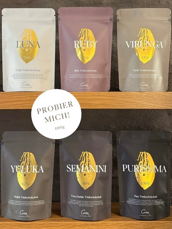Alle sechs Sorten Luna, Ruby, Virunga, Yuluka, Semanini und Purissima im Zipbeutel, Button mit Hinweis Probier Mich je 100g.